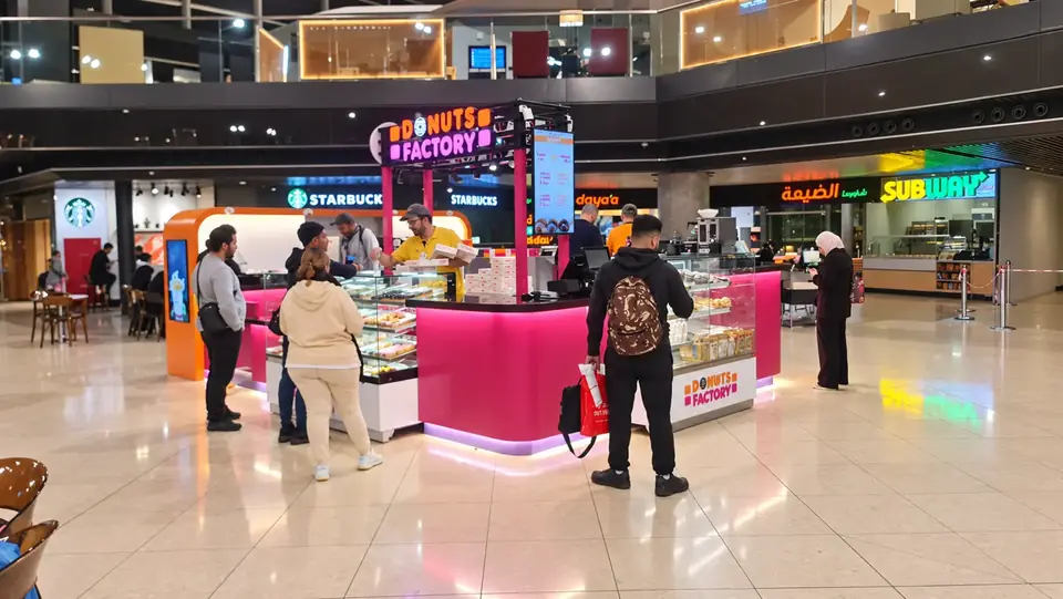 QAI Airport Duty Free airport kiosk · wide view